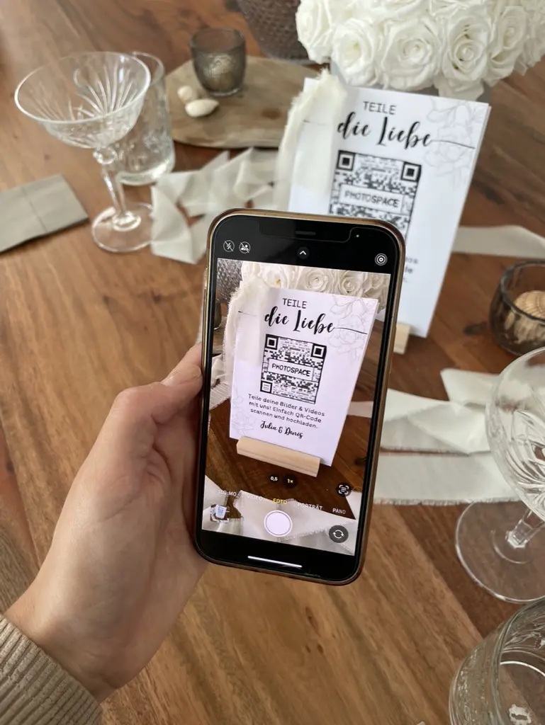 Man with cell phone scans QR code for wedding photos